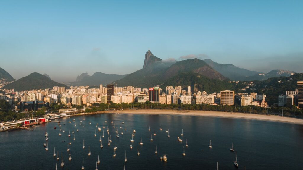 Discover the stunning view of Rio de Janeiro's coastline, featuring iconic mountains and vibrant cityscape.