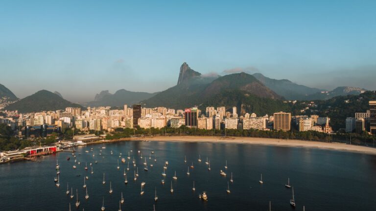 Discover the stunning view of Rio de Janeiro's coastline, featuring iconic mountains and vibrant cityscape.